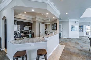 A kitchen with a bar area and a dining area